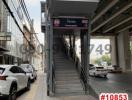 Staircase leading to overhead pedestrian bridge near buildings