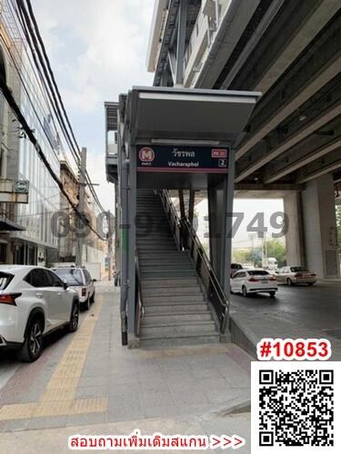 Staircase leading to overhead pedestrian bridge near buildings