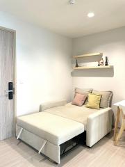 Contemporary small living room with a sofa bed and a wooden floor