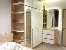 Cozy modern bedroom interior with built-in wardrobe and shelving