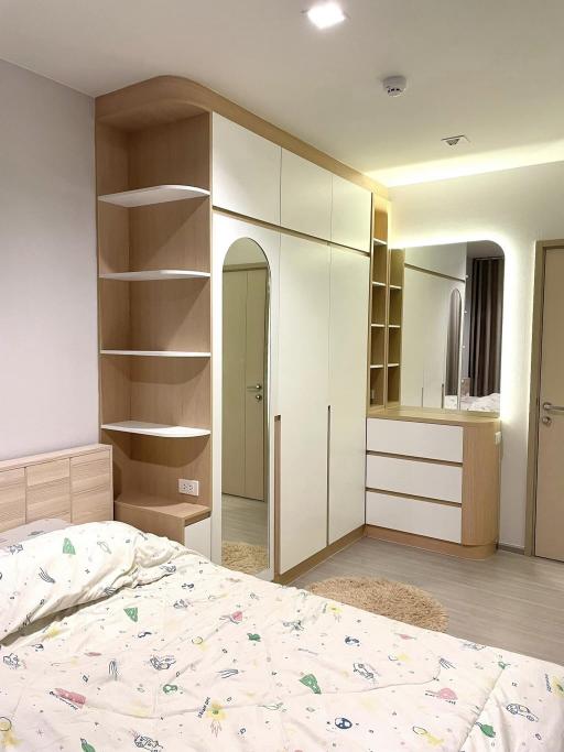 Cozy modern bedroom interior with built-in wardrobe and shelving
