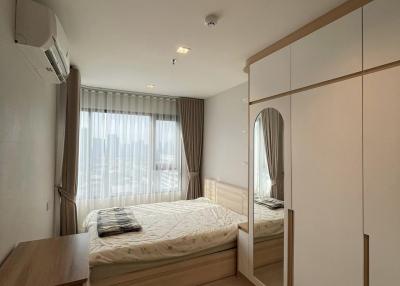 Cozy bedroom with large bed, built-in wardrobes, and ample natural light