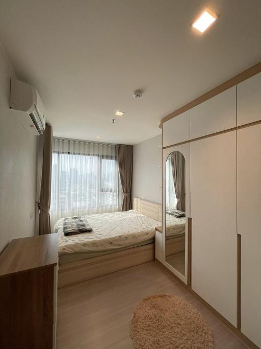 Cozy bedroom with large bed, built-in wardrobes, and ample natural light