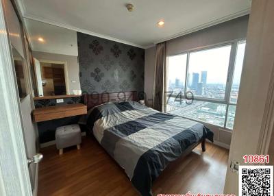 Modern bedroom with panoramic city view and en suite bathroom