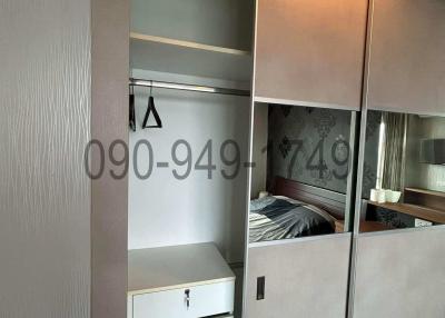 Compact bedroom with built-in wardrobe and mirrored doors