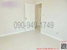 Empty bedroom with white walls and laminate flooring