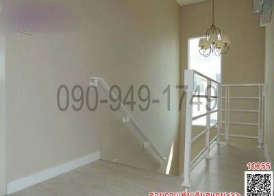 Bright staircase area with chandelier and neutral color walls