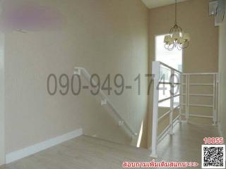 Bright staircase area with chandelier and neutral color walls