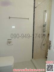 Modern bathroom with white tiles and glass shower