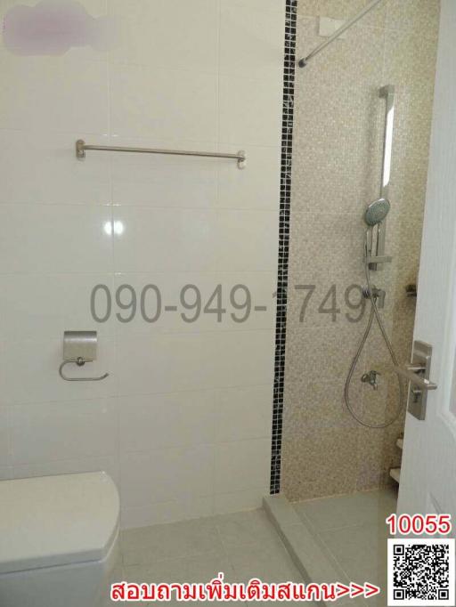 Modern bathroom with white tiles and glass shower