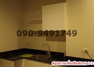 Compact kitchen with modern appliances and QR code