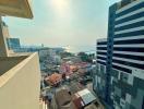 Expansive city and waterfront view from high-rise balcony