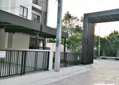 Modern residential building exterior with gated entrance