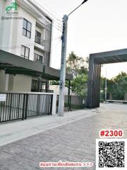 Modern residential building exterior with gated entrance