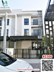 Modern two-story residential building with balcony and gated entrance