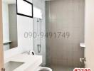 Modern bathroom with white fixtures and gray tiles