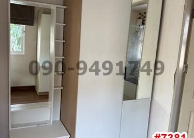 Bedroom with white wardrobe and mirror