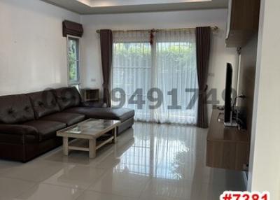 Spacious and well-lit living room with glossy tiled flooring and modern furnishing