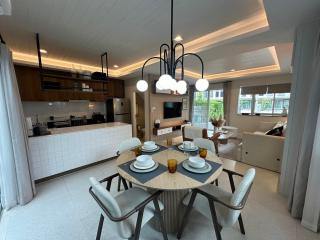 Modern open plan living space with kitchen, dining area, and living room