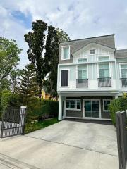 Modern two-story residential home with a spacious driveway and green landscaping