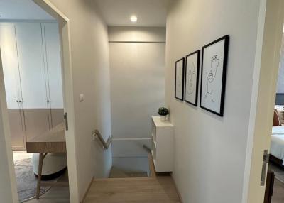 Bright hallway with wooden flooring and modern framed artwork