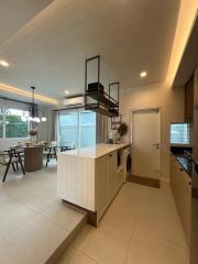 Modern kitchen with integrated dining area, vaulted ceiling and ample natural light