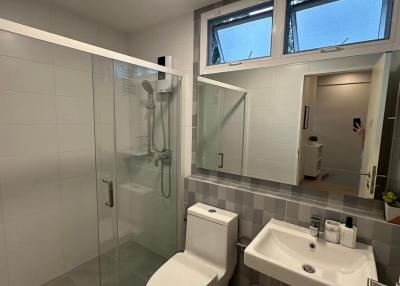 Modern bathroom with glass shower enclosure and skylight windows