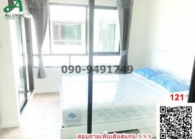 Brightly lit bedroom with large windows and a double bed