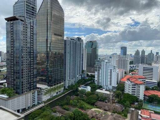 Panoramic city view with skyscrapers and cloudy blue sky seen from a high-rise building