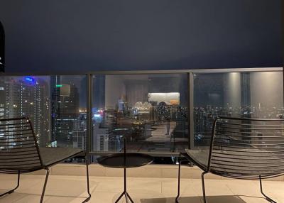 High-rise balcony with a cityscape view at night