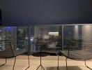 High-rise balcony with a cityscape view at night