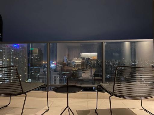 High-rise balcony with a cityscape view at night