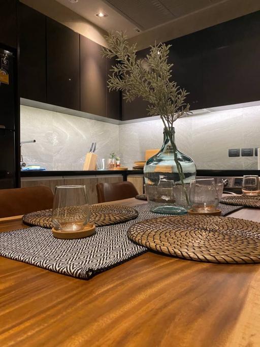 Modern kitchen with dark wood tones and upscale finishes