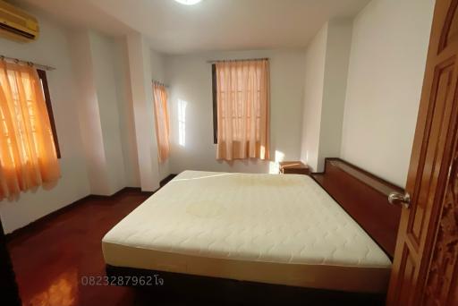 Spacious bedroom with large bed and ample natural light