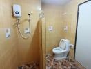 Compact bathroom with tiled walls and floor, featuring a toilet, shower, and water heater