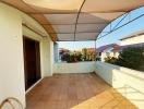 Spacious Balcony with Protective Awning and Residential View