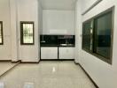 Spacious kitchen with modern cabinetry and glossy tiled flooring