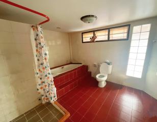 Spacious bathroom with bathtub and natural light