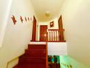 Cozy staircase with wooden railing and decorative wall art