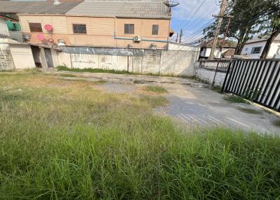 Grassy outdoor area with potential for development near residential building