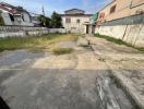 Unpaved lot with surrounding buildings in a residential area