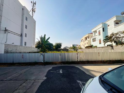 View of an outdoor parking space adjacent to residential buildings