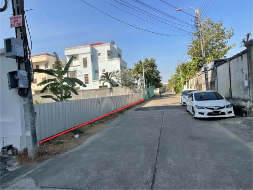 Exterior street view showcasing neighboring buildings and available parking