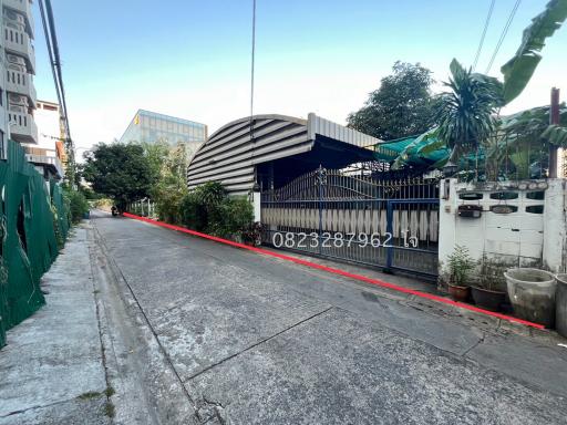 Exterior view of a residential property with gated entrance