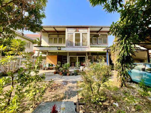 Two-story house with balcony and garden