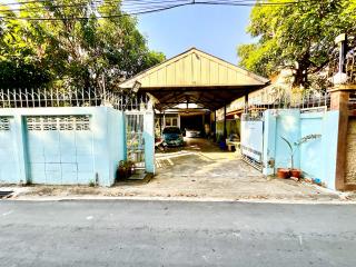 Spacious driveway with covered carport and gated entrance