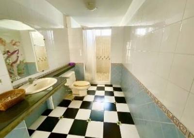 Bright bathroom with checkered floor and bathtub