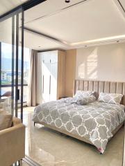 Modern bedroom with large bed and panoramic window