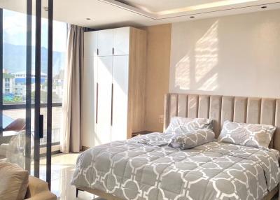 Modern bedroom with large bed and panoramic window