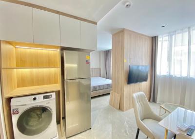 Compact studio apartment with modern appliances and natural light